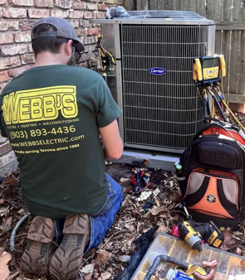 Webb's Electric, Heating & Air technician diagnosing a problem with a Carrier heat pump at a home in Whitesboro